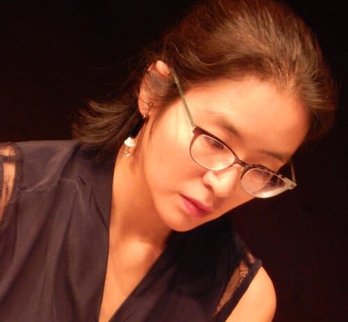 Woman pianist wearing glasses